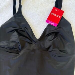 NWT Spanx Shaping Satin Bodysuit
Size  S 
black 
Thong bodysuit 
No underwire